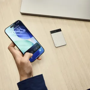 PLAUD Note Pro voice recorder with AI transcription beside a smartphone on a desk